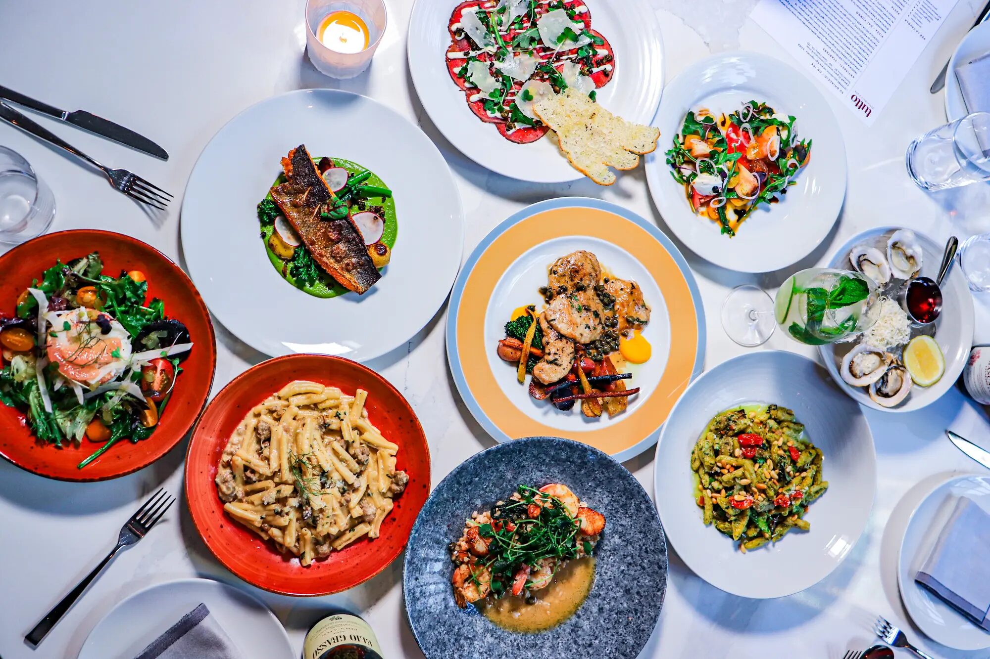 Tutto Restaurant dining spread with Italian dishes